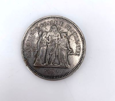 a close up of a coin on a white surface
