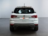 the rear end of a white suv parked in a white room