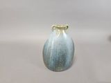 a blue and white vase sitting on a table
