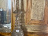 a glass vase sitting on a table next to a mirror