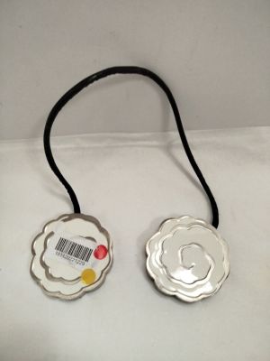 a silver plate with a black cord attached to it