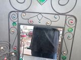 a mirror that is sitting on a table with a lamp