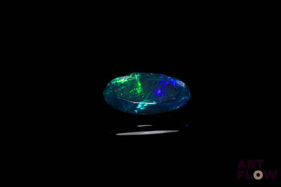 a black oplite with green and blue lights in the dark