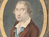 portrait d'un homme vêtu d'un manteau marron et d'une chemise bleue
