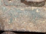a close up of a rusted metal object with a hole in it