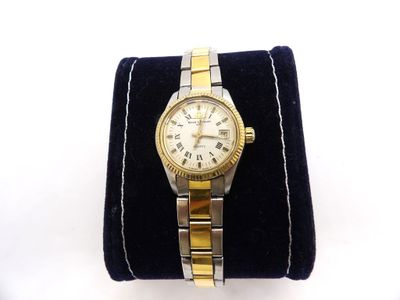 an image of a gold and silver wrist watch on a black velvet case