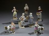 many figurines of people that are standing in a circle