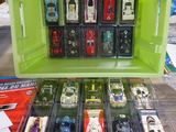 a lot of toy cars that are in a green box