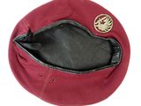 a red hat with a gold emblem on it