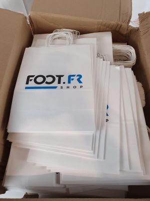 a cardboard box with a bunch of white bags inside of it