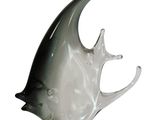 a glass sculpture of a fish on a white background