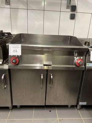 several stainless steel sinks in a commercial kitchen with a tile floor