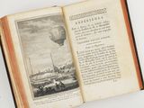 an open book with a picture of a hot air balloon in the sky