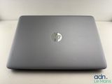 the hp laptop is sitting on a table with its lid open
