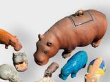 many different types of toy animals on a white surface