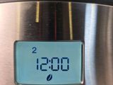 a digital clock on the side of a stainless steel oven