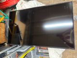 a flat screen tv sitting on top of a pile of boxes