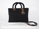 a black handbag with a gold chain on the handle