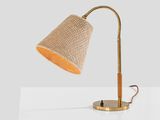 the table lamp is made of wood and has a beige fabric shade
