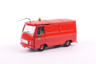 a red toy bus that is sitting on a white surface