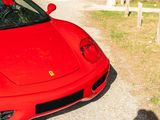 a red sports car parked on the side of the road