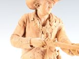 figurine of a man in a cowboy outfit holding a lasset