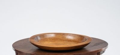 a wooden bowl sitting on top of a wooden table