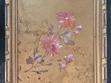 an old picture of a painting of flowers in a gold frame