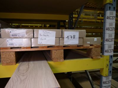 many boxes of wood on a pallet in a warehouse