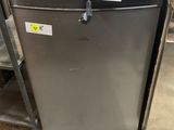a refrigerator that is sitting in the middle of a room