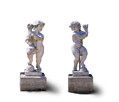 pair of statues of a boy and a girl holding a flower