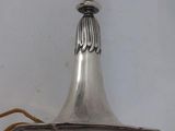 an antique silver plated candle holder with a cord attached to it