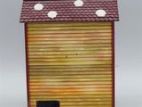 a close up of a birdhouse with three birds on the roof