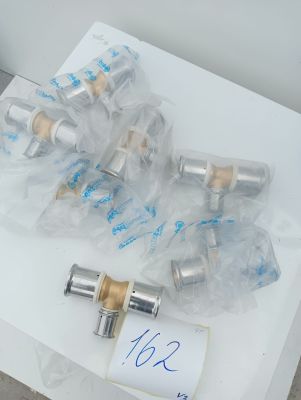several silver and gold valves on a white table with a price tag