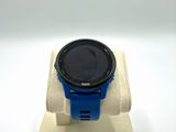 a smart watch sitting on a stand on a white surface