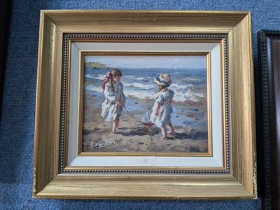 painting of two children playing on the beach in a gold frame