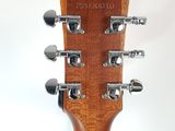 a close up of the headstock of an acoustic guitar
