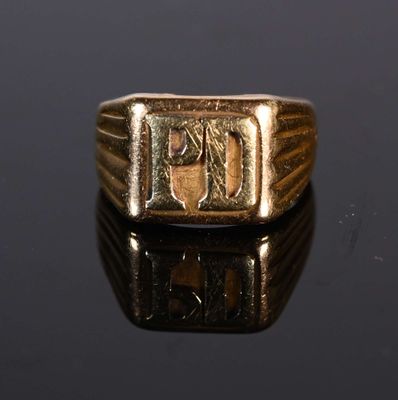 a gold ring with an image of a man ' s face on it