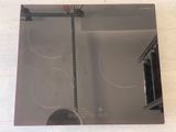 a picture of a kitchen with a glass stove top