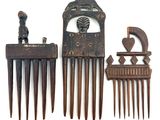 three pieces of hair combs that are on a white surface