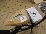 a bike that has a box on the back of it with a pair of shoes in it