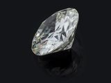 an oval cut diamond on a black surface