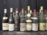 bottles of wine are lined up on a table in front of a black backdrop