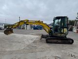 a picture of a small excavator parked in a parking lot