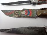 three different types of knives on a white surface
