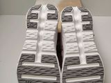 the soles of a pair of running shoes on a white surface