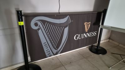 a sign that says guinness on it in front of a projector screen