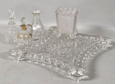a glass tray with a candle holder and other items on it