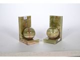 two bookends with a green marble ball on them