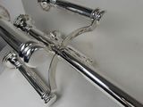two chrome handles on the handlebars of a bathtub
